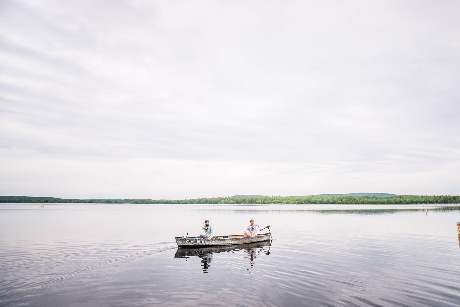 anglers fishing offshore for bass on open water during summer