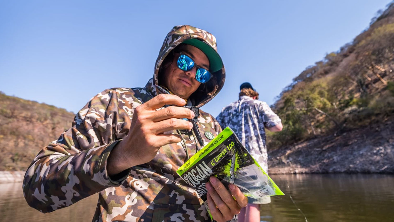 Angler selecting a soft plastic bait from package on a boat