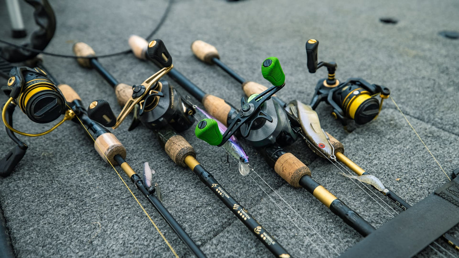 Multiple bass fishing rods and reels on boat deck