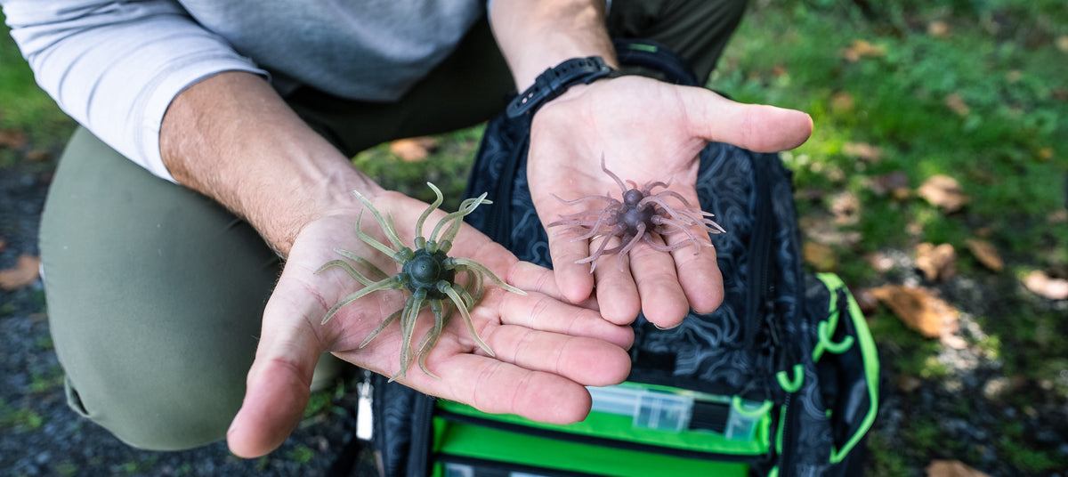 New Googan baits in an angler's hands over a tackle bag